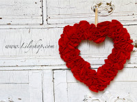 The Valentine Wreath | Lilyshop Blog by Jessie Jane

Materials:

– 1 styrofoam heart shaped wreath from your local craft store
– Scissors
– 1 yard red felt or 125 3″ Red Felt circles
– About 150 1″ Pins
– One 12″ piece of ribbon (ivory or red)