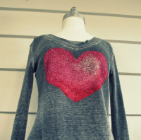 Glitter Heart Tee, DIY | This is a great step by step tutorial how to make this awesome Tee from WobiSobi.

Materials:

 –   A Tee of your choice
–    A heart stencil* I made mine 
–    Masking tape
–    Paper Plate
–    A piece of Parchment paper or foil
–    Three colors of glitter Martha Stewart Glitter in Red *Garnet, Pink* Tourmaline and Light Pink Rose Quartz
– Tulip Stencil Sponge
  –  Tulip Fabric Paint  in Crimson Red, – Hot Pink and Glacier White. 
–    Mod Podge Fabric Glue

Instructions and image credit to the original link  – above the photo.