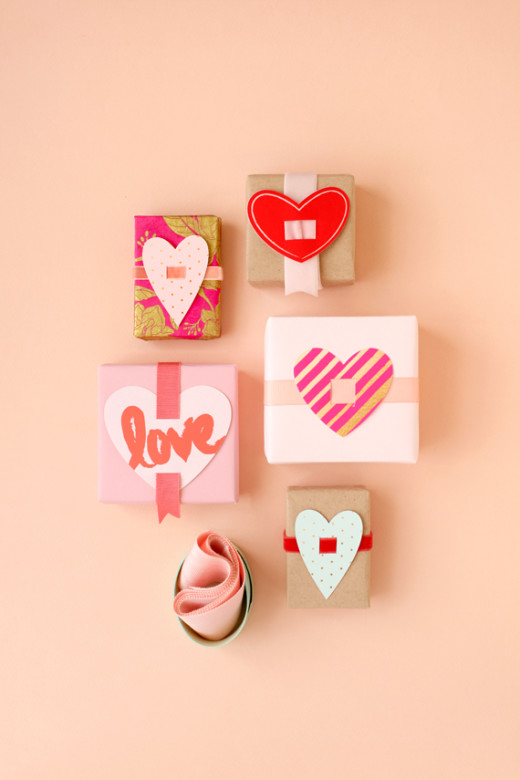 Valentine Present Toppers |  From Julep
Materials:

    – White cardstock
   – Scissors
  – Craft Knife
   – Ribbon
    – Tape